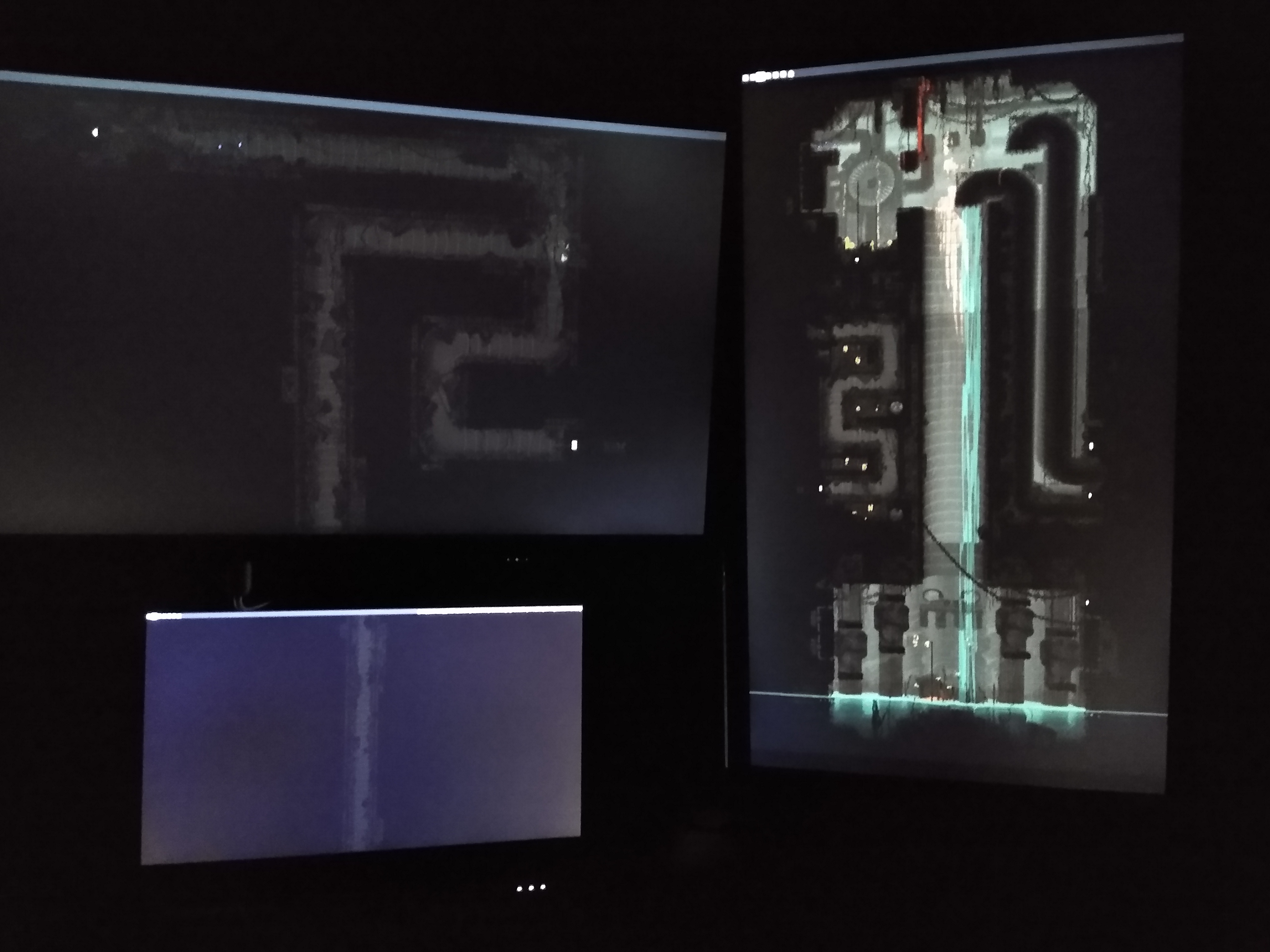 A picture of a computer setup. There are multiple monitors each only displaying a wallpaper, which is stretched across all of the monitors.