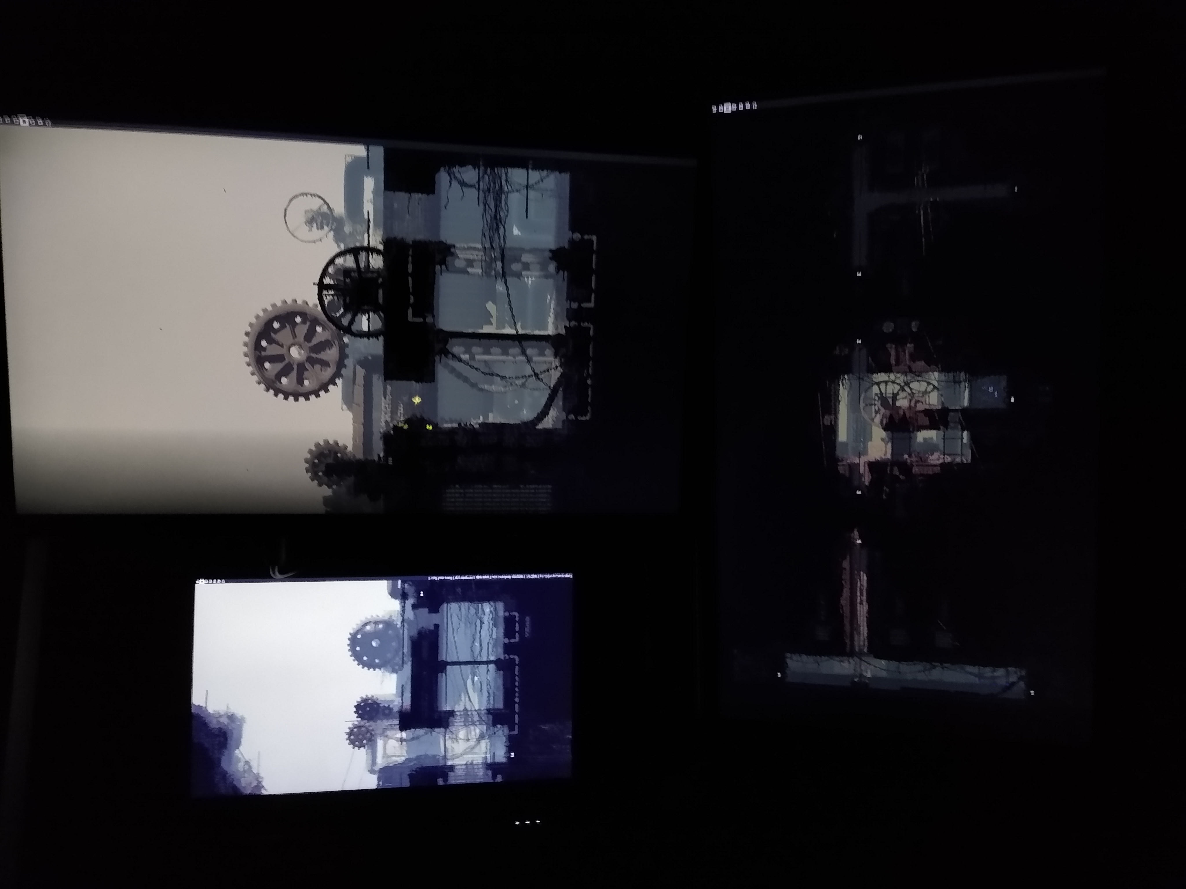 A picture of a computer setup. There are multiple monitors each only displaying a wallpaper, which is stretched across all of the monitors.