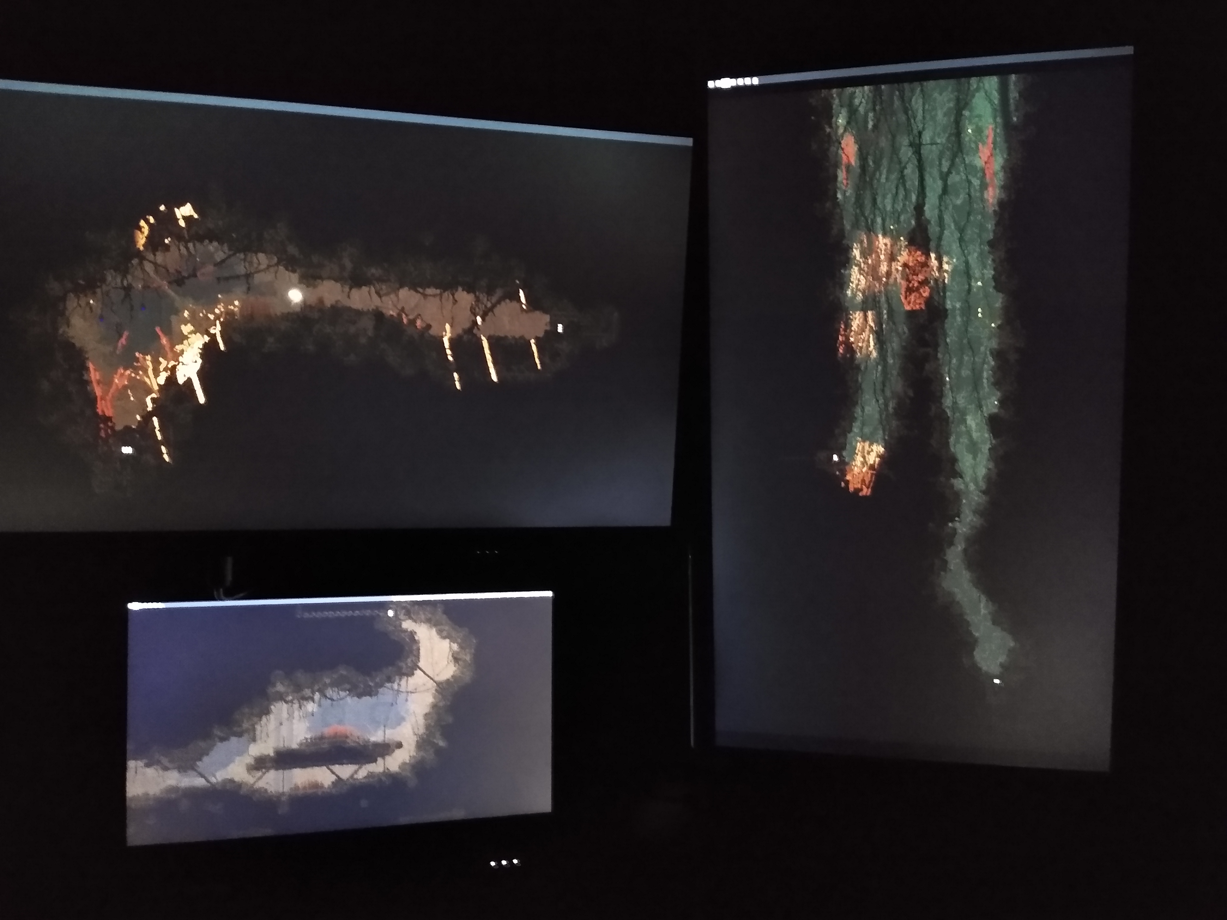 A picture of a computer setup. There are multiple monitors each only displaying a wallpaper, which is stretched across all of the monitors.